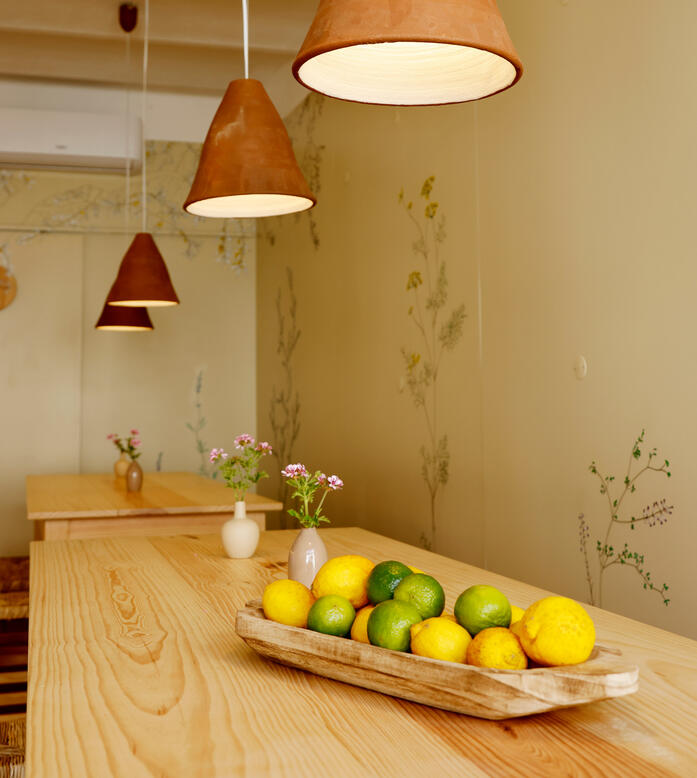 Veggieterraneo interior with clay pendant lights and communal table